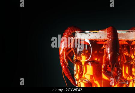 Boiled crawfish crawfish hanging on beer glass. Stock Photo