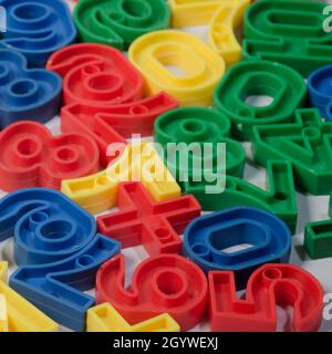 Early Childhood Education, Colorful plastic one to ten number sets in Red, Blue, Green and Yellow colours. in white background. Stock Photo