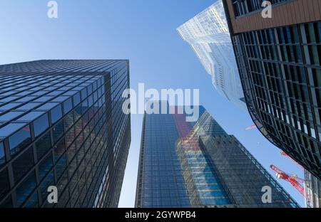 Looking up at the Leadenhall building and surrounding skyscrapers from below on a clear sunny day. London - 9th October 2021 Stock Photo