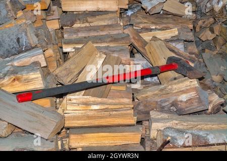 Big cleaver ax on a pile of firewood close-up. Stock Photo