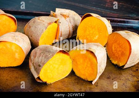 Halves of roasted potatoes on a baking sheet, food closeup Stock Photo ...