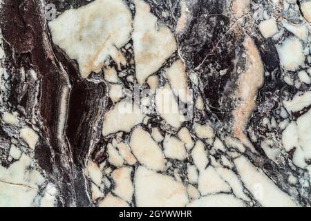 Old, broken, cracked marble. Repaired marble. Stock Photo