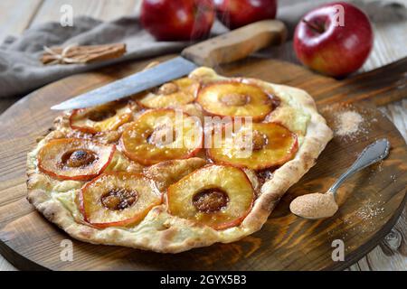 Sweet Tarte Flambée from Alsace with apple rings and candied cinnamon sugar as a dessert hot from the oven Stock Photo