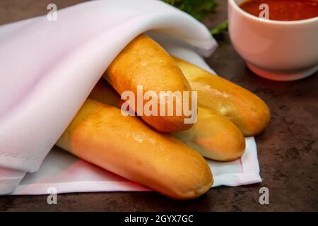 Breadsticks with dipping marinara sauce Stock Photo