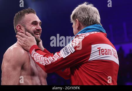 Magdeburg, Germany. 10th Oct, 2021. Boxing: World Championship light heavyweight, IBO, WBA (Interim), Krasniqi (Gersthofen) - Bösel (Freyburg). Dominic Bösel (l) cheers with his trainer Georg Bramowski after the fight. Credit: Ronny Hartmann/dpa/Alamy Live News Stock Photo