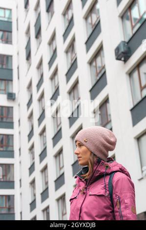 11th of October, Novosibirsk, Russia: portrait of woman on the multu-story building background Stock Photo