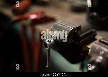 Working tools in the garage. Details of the metal workshop. Hand tools for processing steel billets. Stock Photo