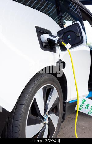 Gateshead UK: 26th Sept 2021: A hand-held closeup of an electric BMW car on charge (EV, green sustainable travel) Stock Photo