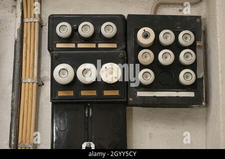 Old electrical fuse box with porcelain fuses in an older dwelling house, power and energy concept, selected focus Stock Photo