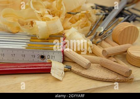 Various carpentry tools, dowels and wood shavings Stock Photo