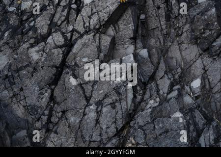 Dark rocks on the Bangor to Holywood coastal path Northern Ireland Stock Photo