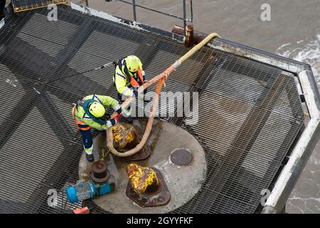 Workers release the mooring rope of MS Stena Embla at Birkenhead docks for a daytime crossing from Liverpool Birkenhead to Belfast Stock Photo