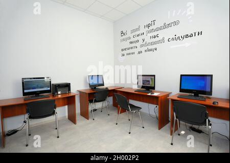 Laptops monitors set on tables in a computer room of the Municipal Department of rehabilitation. October 6, 2021. Kyiv, Ukraine Stock Photo