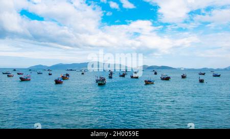 Traditional Vietnamese fishing boats parked and floating in the water after a long day of work in Nha Trang Bay, Vietnam Stock Photo