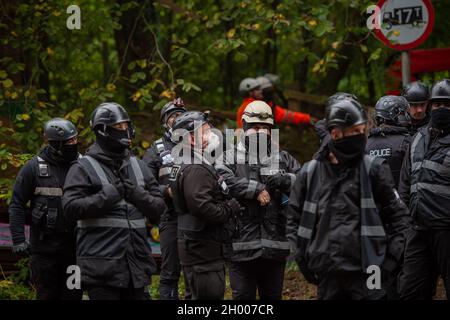 Aylesbury Vale, UK. 10th October, 2021. National Eviction Team bailiffs working for HS2 assisted by HS2 Security and Thames Valley Police were trying to evict anti HS2 protesters holed up in big woodland fortresses at the WAR Against HS2 camp this morning. The land off the A413 just outside Wendover is owned by Buckinghamshire Council but has been seized by court order by HS2 Ltd. The High Speed Rail 2 rail construction is having a devastating impact upon woodland and wildlife sites in Wendover. Credit: Maureen McLean/Alamy Live News Stock Photo