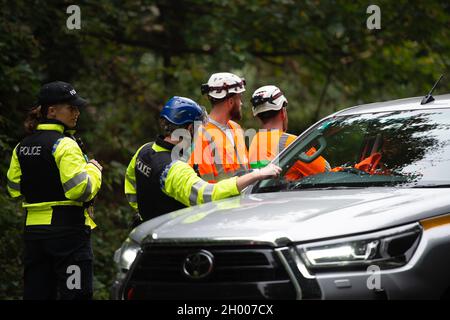 Aylesbury Vale, UK. 10th October, 2021. National Eviction Team bailiffs working for HS2 assisted by HS2 Security and Thames Valley Police were trying to evict anti HS2 protesters holed up in big woodland fortresses at the WAR Against HS2 camp this morning. The land off the A413 just outside Wendover is owned by Buckinghamshire Council but has been seized by court order by HS2 Ltd. The High Speed Rail 2 rail construction is having a devastating impact upon woodland and wildlife sites in Wendover. Credit: Maureen McLean/Alamy Live News Stock Photo