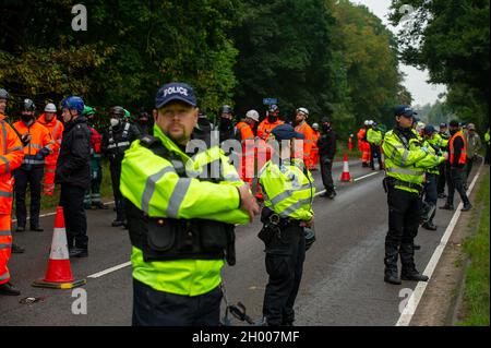 Aylesbury Vale, UK. 10th October, 2021. National Eviction Team bailiffs working for HS2 assisted by HS2 Security and Thames Valley Police were trying to evict anti HS2 protesters holed up in big woodland fortresses at the WAR Against HS2 camp this morning. The land off the A413 just outside Wendover is owned by Buckinghamshire Council but has been seized by court order by HS2 Ltd. The High Speed Rail 2 rail construction is having a devastating impact upon woodland and wildlife sites in Wendover. Credit: Maureen McLean/Alamy Live News Stock Photo