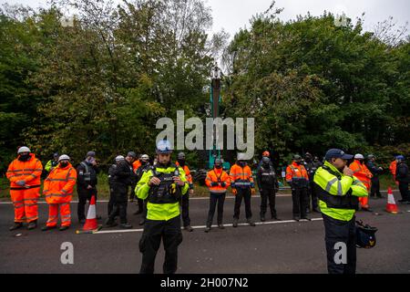 Aylesbury Vale, UK. 10th October, 2021. National Eviction Team bailiffs working for HS2 assisted by HS2 Security and Thames Valley Police were trying to evict anti HS2 protesters holed up in big woodland fortresses at the WAR Against HS2 camp this morning. The land off the A413 just outside Wendover is owned by Buckinghamshire Council but has been seized by court order by HS2 Ltd. The High Speed Rail 2 rail construction is having a devastating impact upon woodland and wildlife sites in Wendover. Credit: Maureen McLean/Alamy Live News Stock Photo