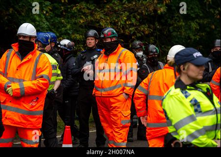 Aylesbury Vale, UK. 10th October, 2021. National Eviction Team bailiffs working for HS2 assisted by HS2 Security and Thames Valley Police were trying to evict anti HS2 protesters holed up in big woodland fortresses at the WAR Against HS2 camp this morning. The land off the A413 just outside Wendover is owned by Buckinghamshire Council but has been seized by court order by HS2 Ltd. The High Speed Rail 2 rail construction is having a devastating impact upon woodland and wildlife sites in Wendover. Credit: Maureen McLean/Alamy Live News Stock Photo