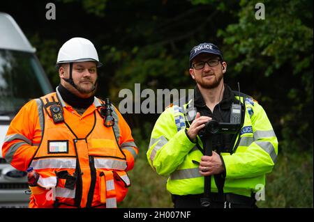 Aylesbury Vale, UK. 10th October, 2021. National Eviction Team bailiffs working for HS2 assisted by HS2 Security and Thames Valley Police were trying to evict anti HS2 protesters holed up in big woodland fortresses at the WAR Against HS2 camp this morning. The land off the A413 just outside Wendover is owned by Buckinghamshire Council but has been seized by court order by HS2 Ltd. The High Speed Rail 2 rail construction is having a devastating impact upon woodland and wildlife sites in Wendover. Credit: Maureen McLean/Alamy Live News Stock Photo