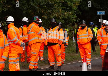 Aylesbury Vale, UK. 10th October, 2021. National Eviction Team bailiffs working for HS2 assisted by HS2 Security and Thames Valley Police were trying to evict anti HS2 protesters holed up in big woodland fortresses at the WAR Against HS2 camp this morning. The land off the A413 just outside Wendover is owned by Buckinghamshire Council but has been seized by court order by HS2 Ltd. The High Speed Rail 2 rail construction is having a devastating impact upon woodland and wildlife sites in Wendover. Credit: Maureen McLean/Alamy Live News Stock Photo