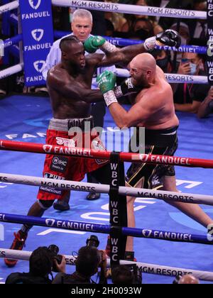 Las Vegas, United States. 10th Oct, 2021. Deontay Wilder (left) and Tyson Fury exchange punches during the Tyson Fury vs Deontay Wilder III 12-round Heavyweight boxing match, at the T-Mobile Arena in Las Vegas, Nevada on Saturday, October 9th, 2021. Photo by James Atoa/UPI Credit: UPI/Alamy Live News Stock Photo