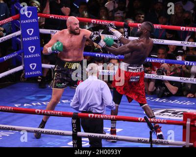 Las Vegas, United States. 10th Oct, 2021. Tyson Fury (left) exchanges blows with Deontay Wilder during the Tyson Fury vs Deontay Wilder III 12-round Heavyweight boxing match, at the T-Mobile Arena in Las Vegas, Nevada on Saturday, October 9th, 2021. Photo by James Atoa/UPI Credit: UPI/Alamy Live News Stock Photo