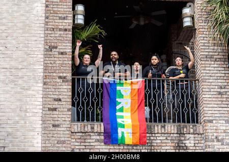 Spectators from a balcony watch the Come Out With Pride Festival and Parade in downtown Orlando Florida on October 9, 2021. Tens of thousands of members of the LGBTQ community and their allies gathered for the annual event in Lake Eola Park. (Photo by Ronen Tivony/Sipa USA) *** Please Use Credit from Credit Field *** Stock Photo