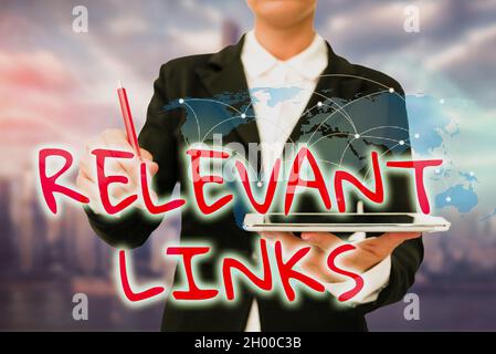 Text sign showing Relevant Links. Business concept Significant sites for a particular topic Associated Lady In Uniform Standing Holding Tablet Typing Stock Photo