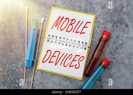 Handwriting text Mobile Devices. Word Written on A portable computing device like smartphone tablet computer Researching Preventive Medications, Viral Stock Photo