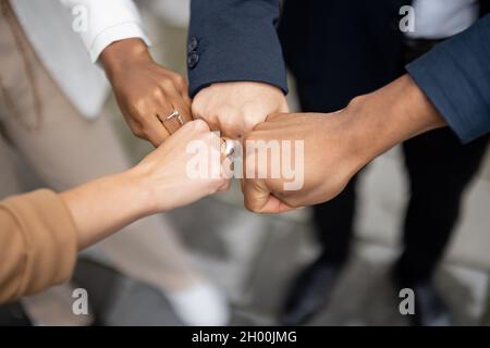 Cropped image of team bumping fists each other Stock Photo