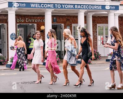 Racegoers all dressed up for a day's horse racing on a summer weekend event at York Racecourse York, North Yorkshire, England UK 2021 Stock Photo