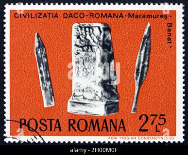 ROMANIA - CIRCA 1976: a stamp printed in Romania shows Sword, Lance and Tombstone, Daco-Roman Archaeological Treasure, circa 1976 Stock Photo
