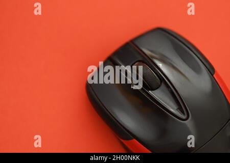 Photo of a black and red computer mouse on a red background Stock Photo