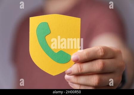 A person holding a shield with a call sign on it Stock Photo