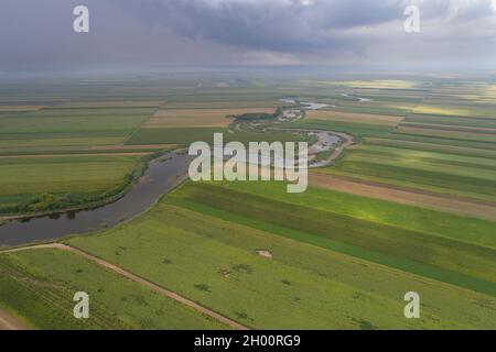 Aerial image of winding river in agricultural fields shoot from drone Stock Photo