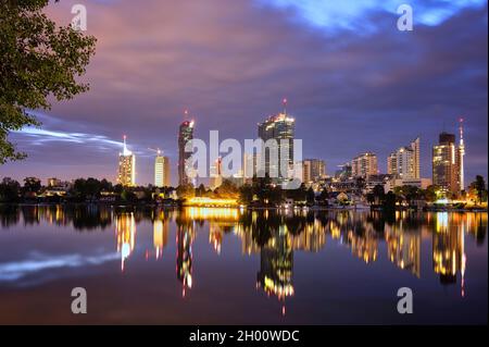 Vienna skyline by night with reflections in Danube Stock Photo