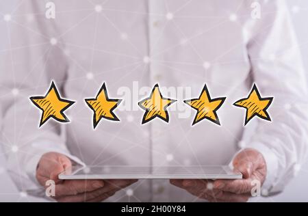 Quality concept above a tablet held by a man in background Stock Photo