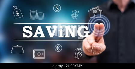 Man touching a saving concept on a touch screen with his fingers Stock Photo