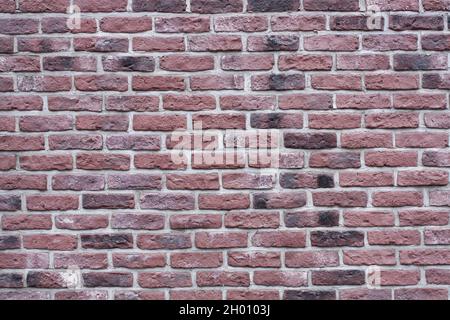 Textured background of an old dark red brick wall. Old brickwork. Stock Photo