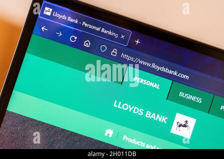 Closeup of the UK bank Lloyds logo and website home screen on a laptop screen. England Stock Photo