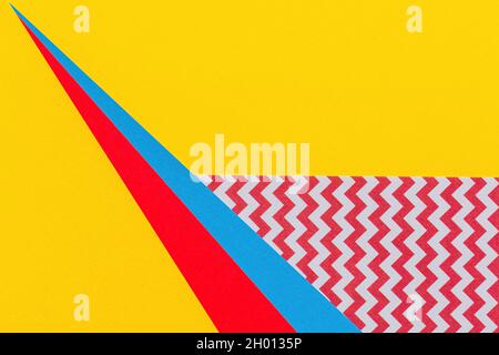 Abstract geometric fashion papers texture background in yellow, red, pink, blue colors. Top view, flat lay Stock Photo