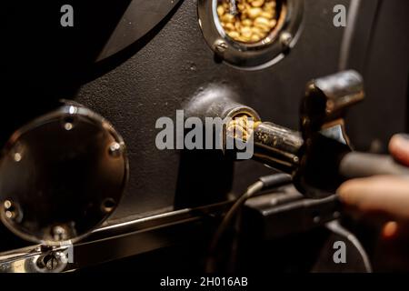 Male worker using industrial coffee roasting machine Stock Photo