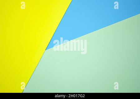 Abstract background from sheets of yellow, blue and green paper.  background with geometric shapes. Thick paper of different colors top view. Abstract Stock Photo