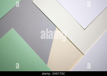 Abstract background from sheets of white, gray and green paper.  background with geometric shapes. Thick paper of different colors top view. Abstract Stock Photo