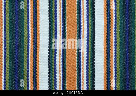 Color linen fabric with a thin strip, background. Linen fabric texture. Kitchen towel close-up. Home textiles made from natural fabric. Stock Photo
