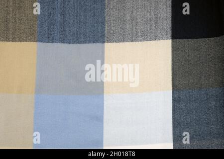 Checkered fabric texture. Woolen winter scarf background. Close-up of warm soft fabric in a cage. Textiles for tailoring. Stole with a check pattern i Stock Photo
