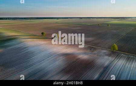 Aerial image of agricultural fields in plains in spring time shoot from drone Stock Photo