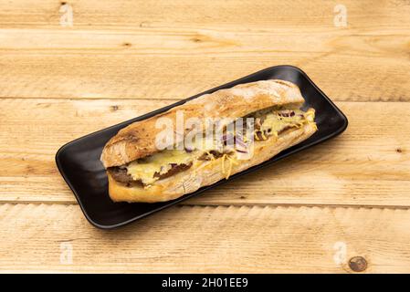 Beef sandwich cooked in kebab style with melted cheese and red onion and village bread Stock Photo