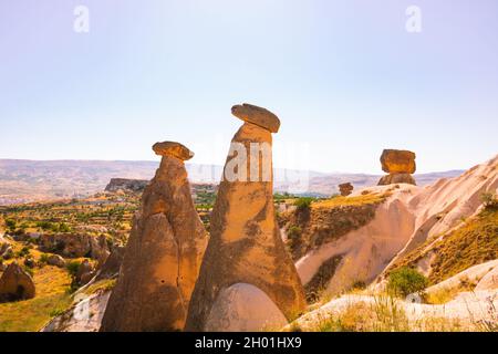 Three graces or Uc Guzeller in Turkish in Cappadocia Urgup Turkey. Beautiful fairy chimneys in Cappadocia. Landmarks of Turkey. Tourism day. Stock Photo